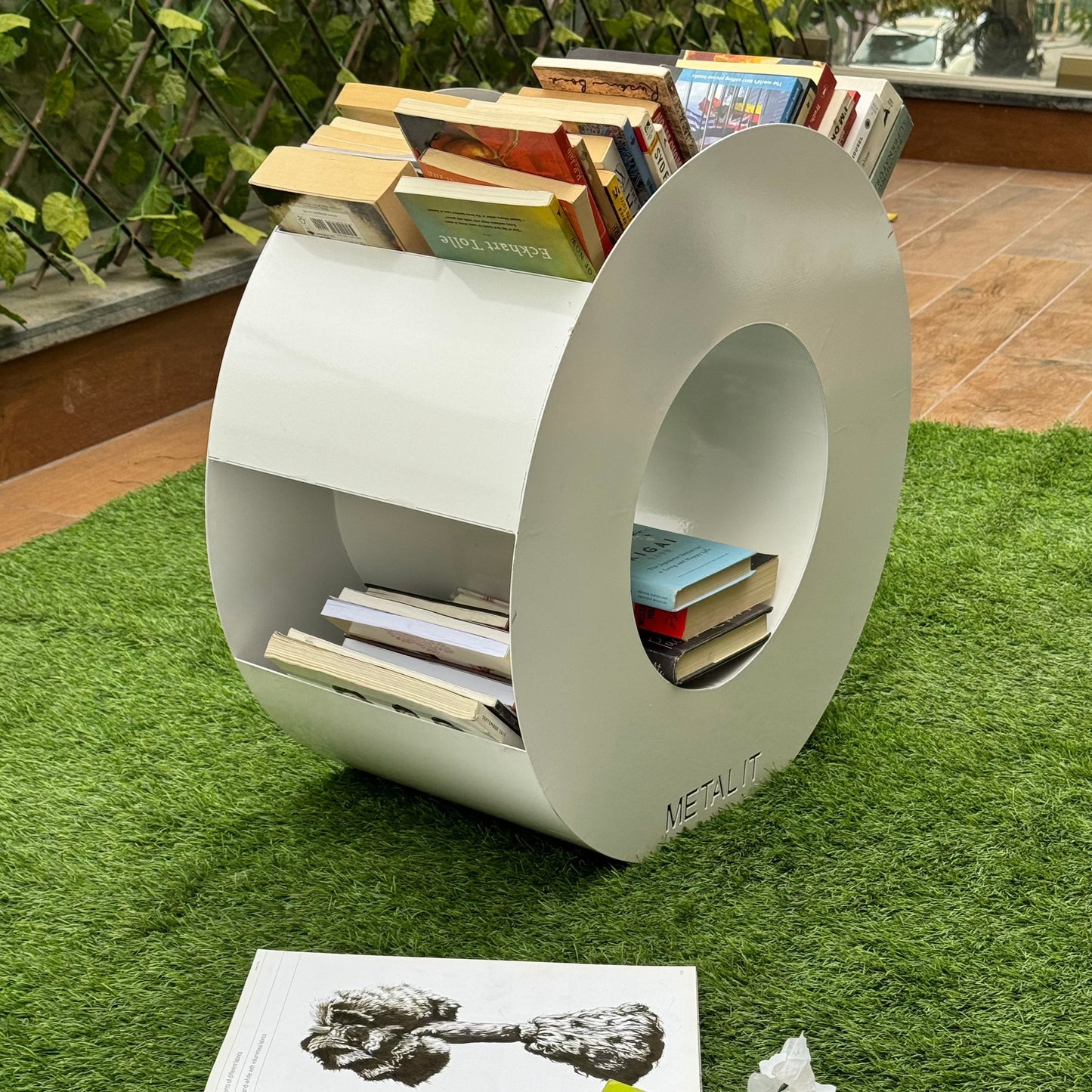 O shaped organiser stand which can be used in bedroom, livingroom, garden or any place you need a stylish storage. It has a  lot of space, can easily store more than 50 books too!