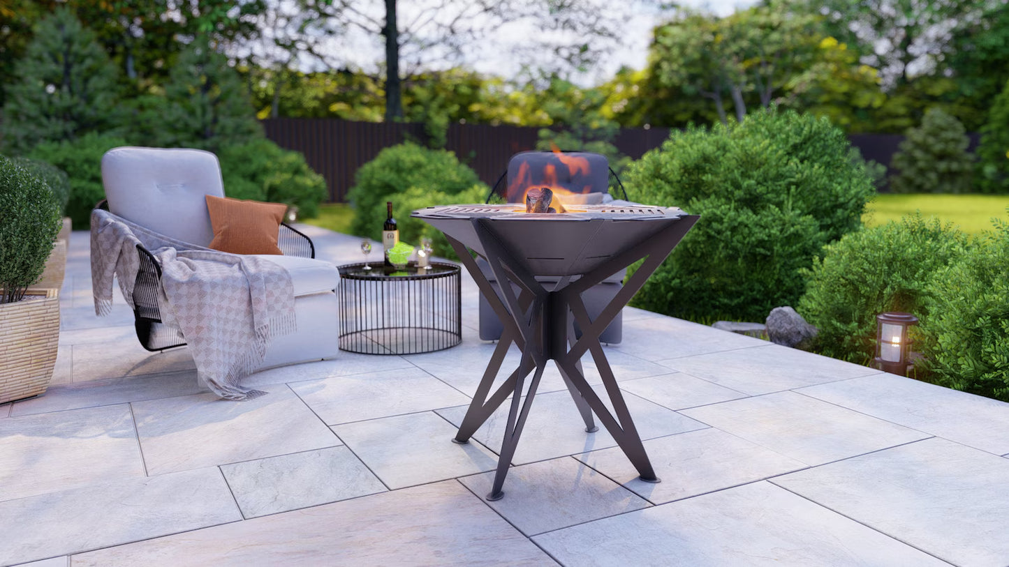 Outdoor patio with fire pit, chairs, and table in a garden setting