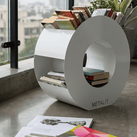 White circular bookshelf with books and a plant on a balcony with cityscape view