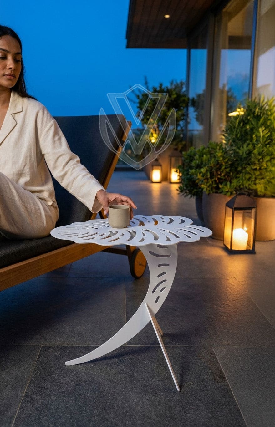 Woman sitting on a patio at night with a small table and candles